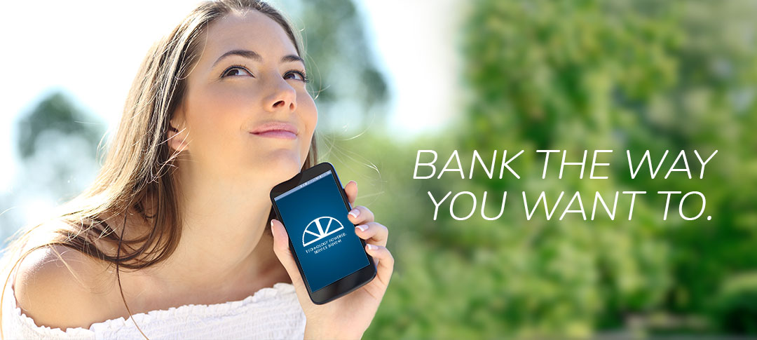 Bank the way you want to. Use The Bank of Marion app. Woman holding phone and smiling.